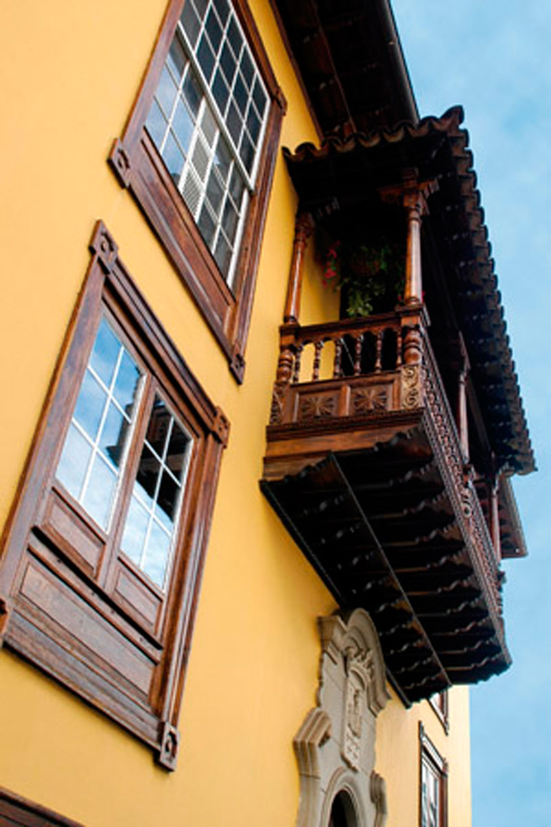 Wooden balcony and windows on a yellow house in La Orotava, Tenerife.