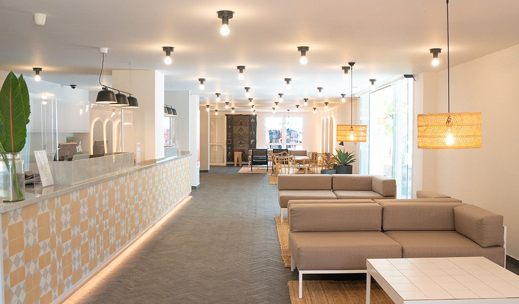 Hotel lobby with beige sofas, pendant lights, and a reception desk in Tenerife.