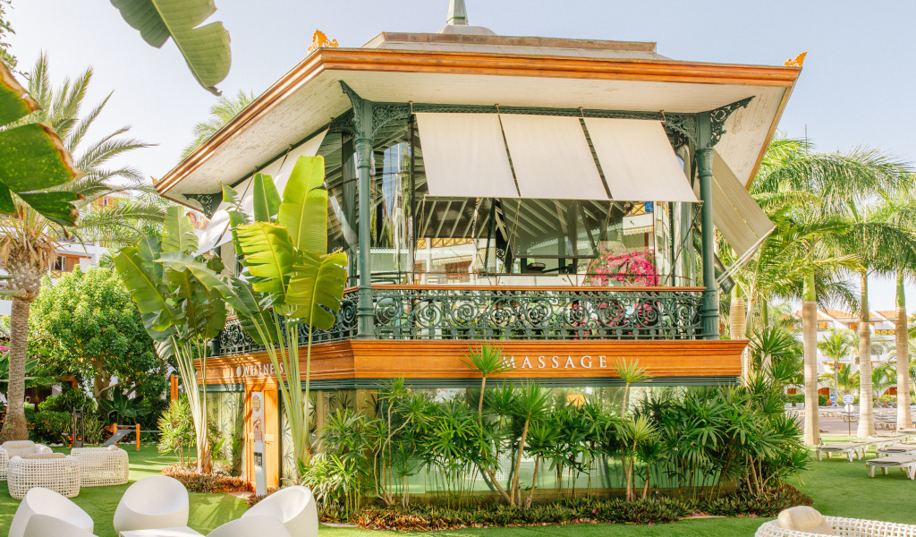Ornate massage kiosk with plants, located in Tenerife garden area.