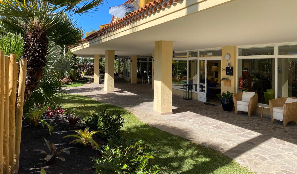 Entrance to a building with patio chairs and plants in Puerto de la Cruz, Tenerife.