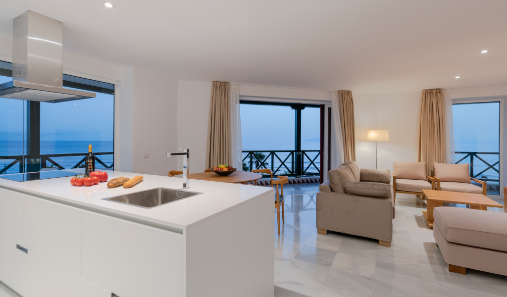 Modern kitchen and living room with sea view in Tenerife apartment.