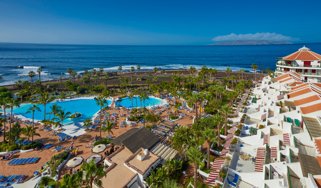 Oceanfront resort with pools and palm trees in Tenerife.