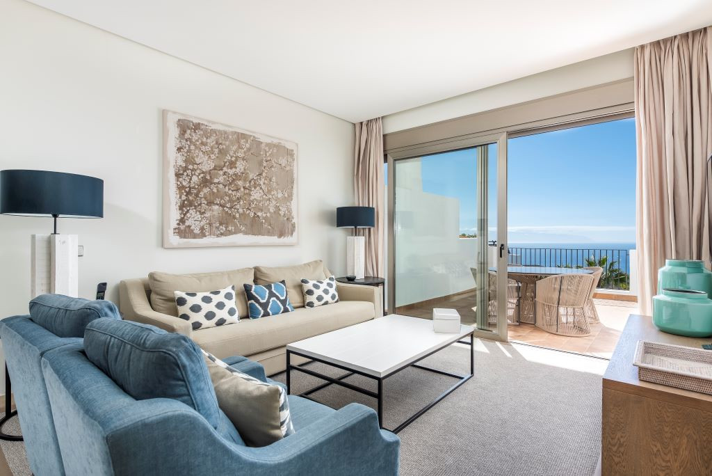 Living room with ocean view through large window in Tenerife.