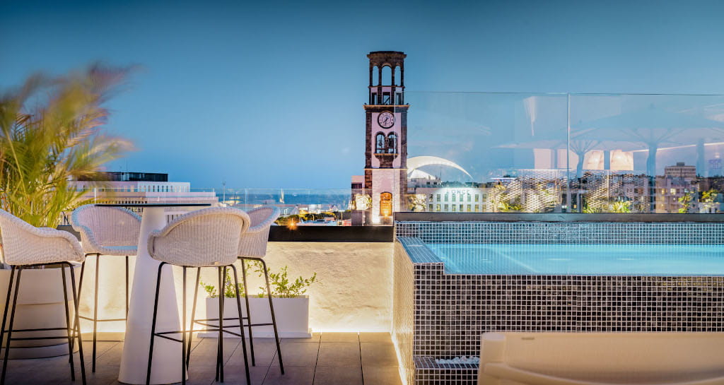 Rooftop terrace with pool and clock tower view in Tenerife.