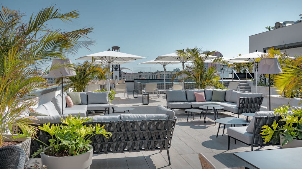 Rooftop terrace with seating, umbrellas, and plants in Tenerife.