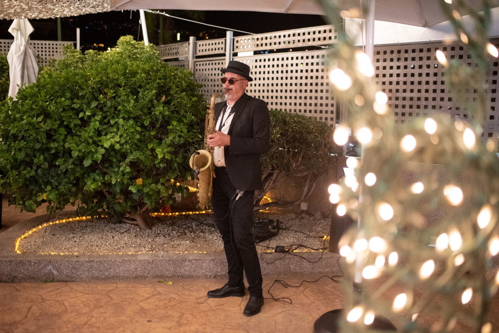 Saxophonist performing outdoors at a nighttime event in Tenerife.
