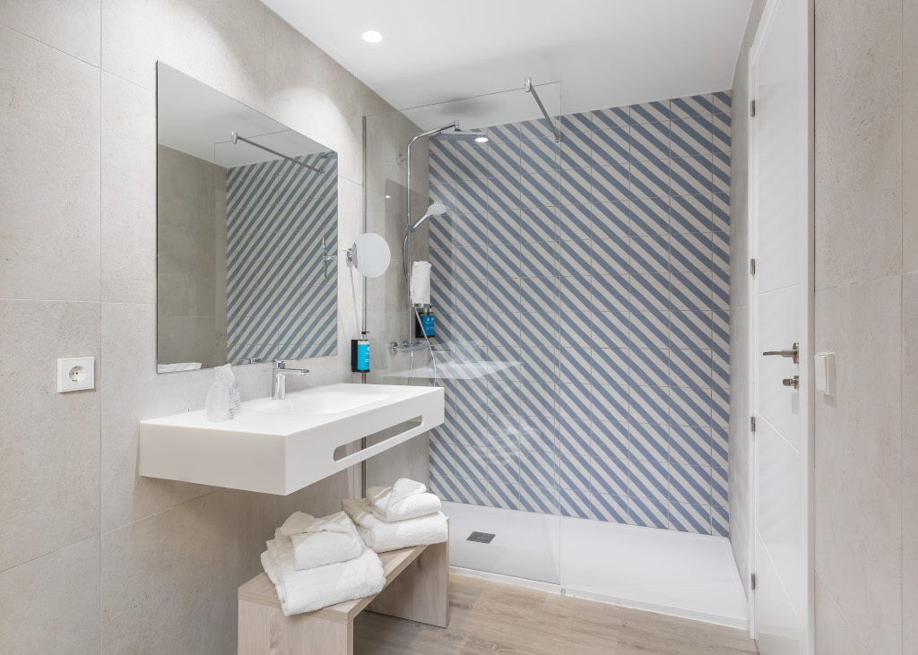 Modern bathroom with striped shower in a Tenerife hotel.