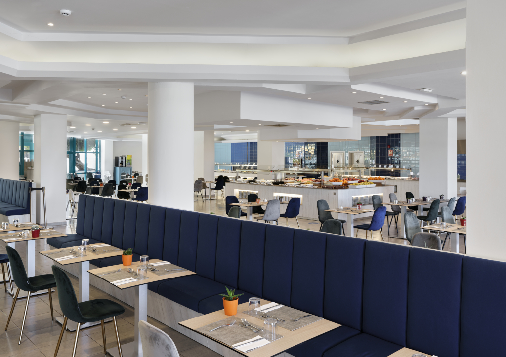 Restaurant seating and buffet area in Tenerife with tables and chairs arranged neatly.