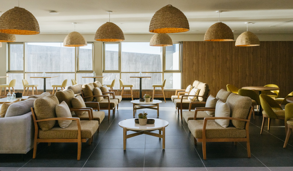 Spacious lounge area with sofas and wicker lamps in Tenerife.