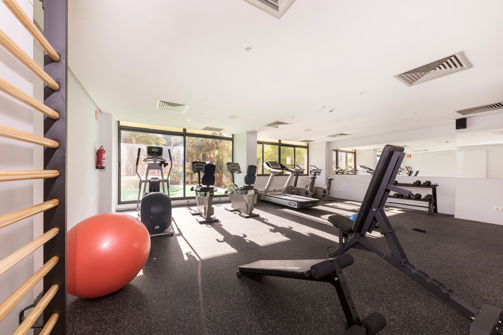 Gym with exercise equipment and red stability ball in a bright room, Tenerife.