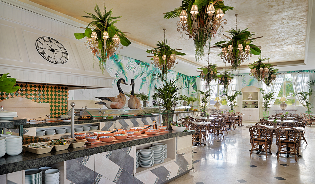 Restaurant buffet with tropical decor and tables at a Tenerife hotel.