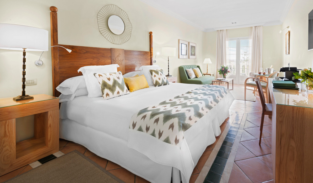 Elegant hotel room with double bed and sitting area in Tenerife.
