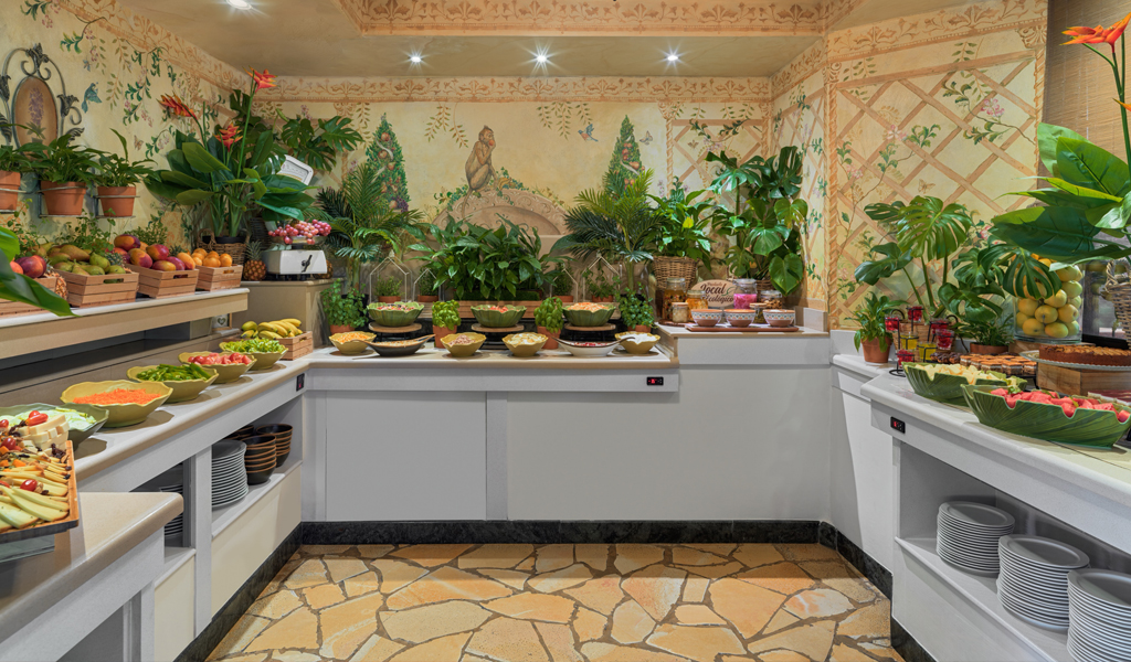 Buffet with various fruits and salads in a Tenerife hotel dining room.