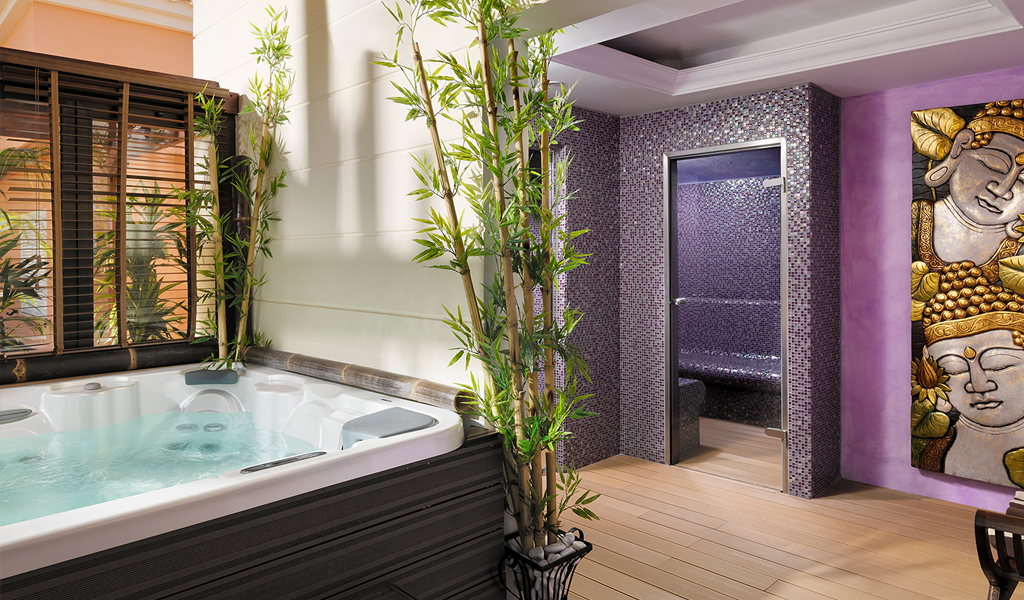 Spa room with hot tub and steam room, decorated with bamboo and a Buddha painting in Tenerife.