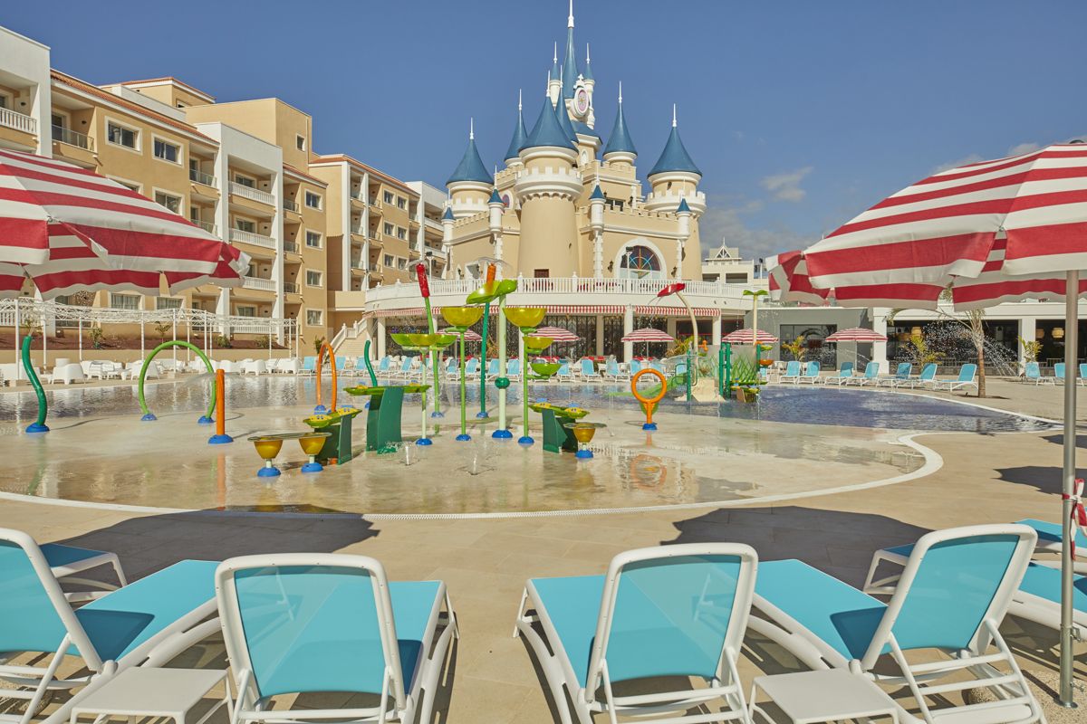 Children's water play area with castle backdrop at a Tenerife resort.