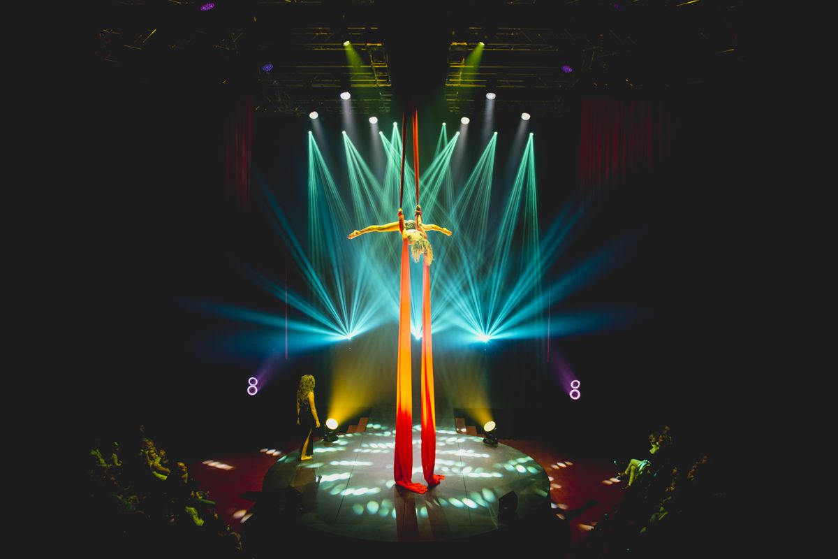 Performer doing aerial silk acrobatics on stage in Tenerife.
