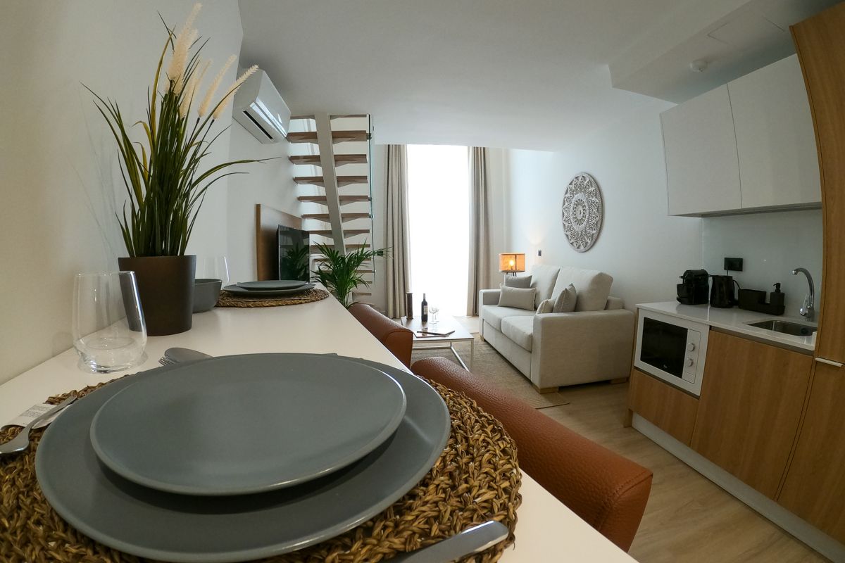 Kitchen and living area with modern decor in a Tenerife apartment.