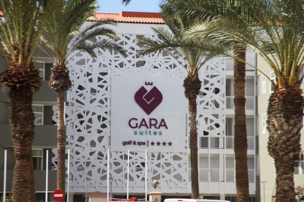 Gara Suites sign surrounded by palm trees in Tenerife.