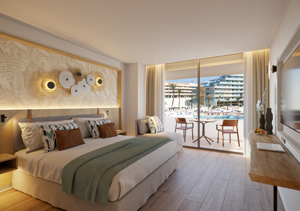 Hotel room with balcony view of pool and modern buildings in Tenerife.