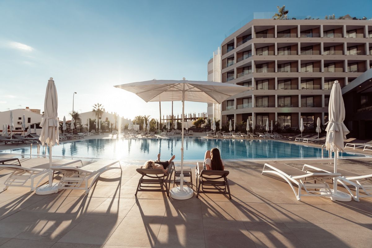 Hotel pool with sun loungers and umbrellas in Tenerife.