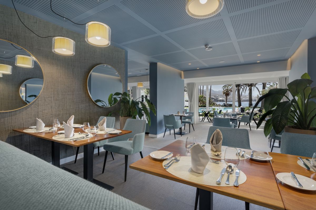 Restaurant with set tables and pool view in Tenerife.