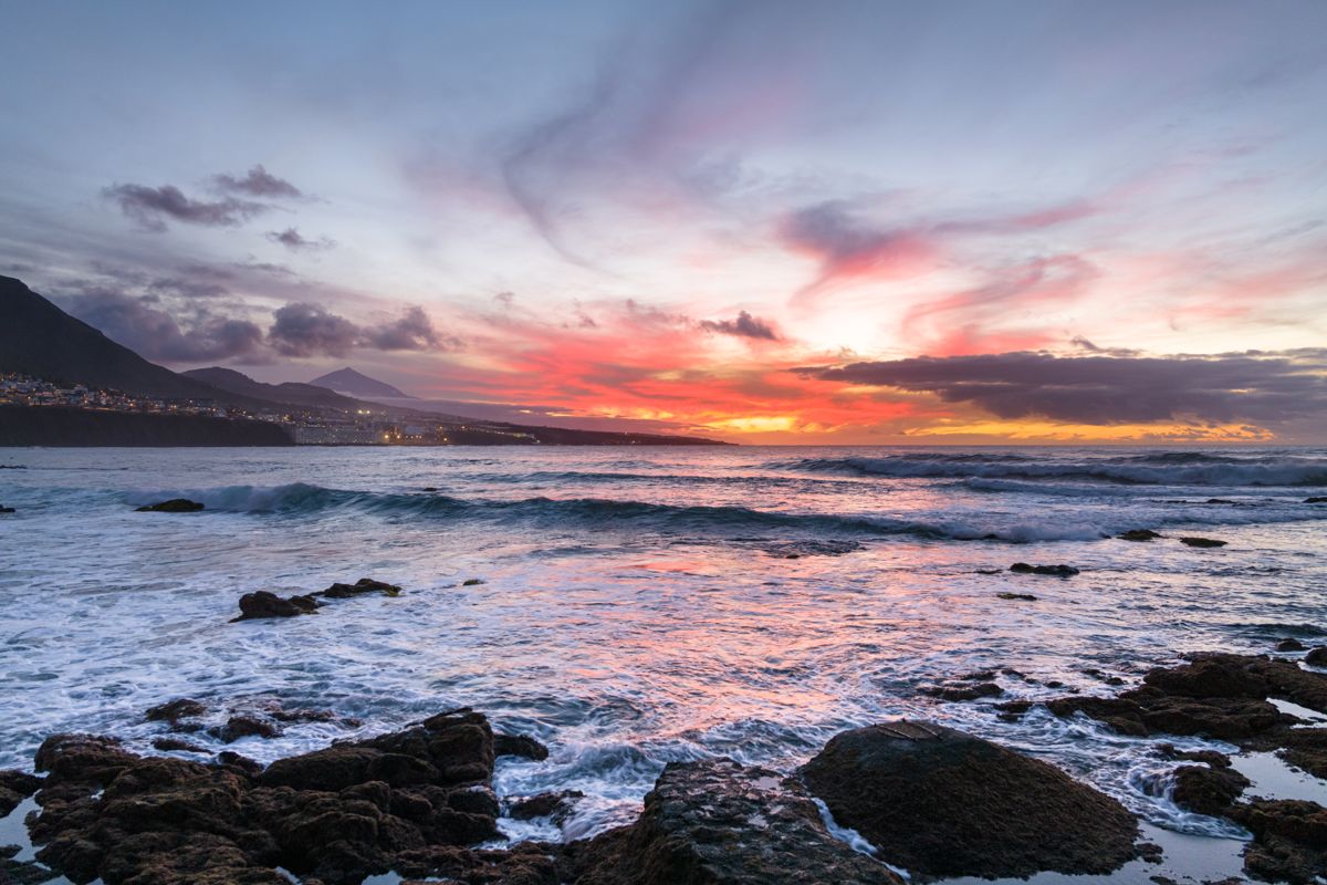 Sunset view over the ocean with mountains in Puerto de la Cruz, Tenerife.