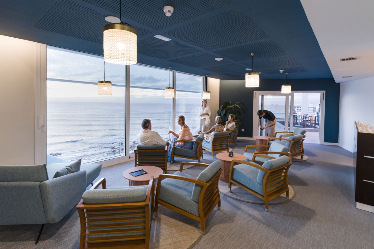 People relaxing in a lounge with ocean view in Tenerife.