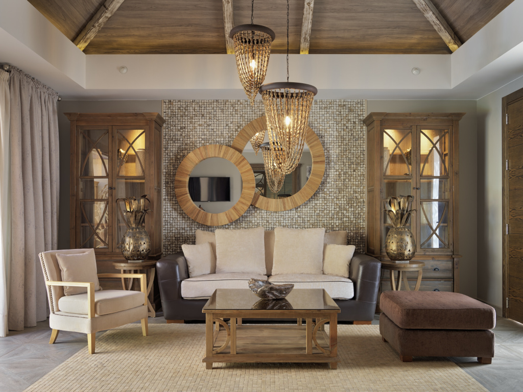 Living room with sofa, armchair, two mirrors, and decorative cabinets in Adeje, Tenerife.