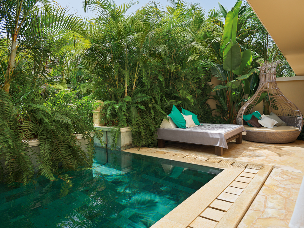 Outdoor lounge area with pool and tropical plants in Tenerife.