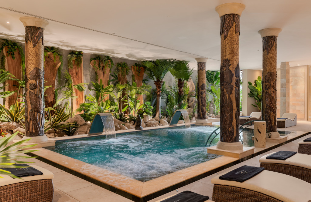 Indoor spa with decorative columns and tropical plants at a Tenerife wellness resort.