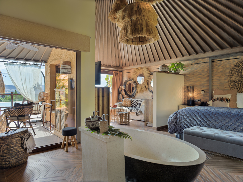 Luxurious room with bathtub, bed, and terrace view in Tenerife hotel.