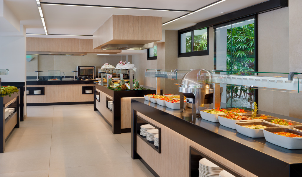 Buffet with various dishes and fresh salads in a Tenerife hotel's dining area.