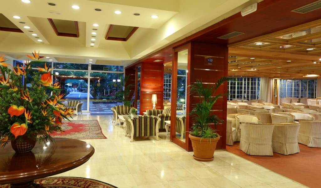 Lobby with floral arrangement and seating area in a Tenerife hotel.