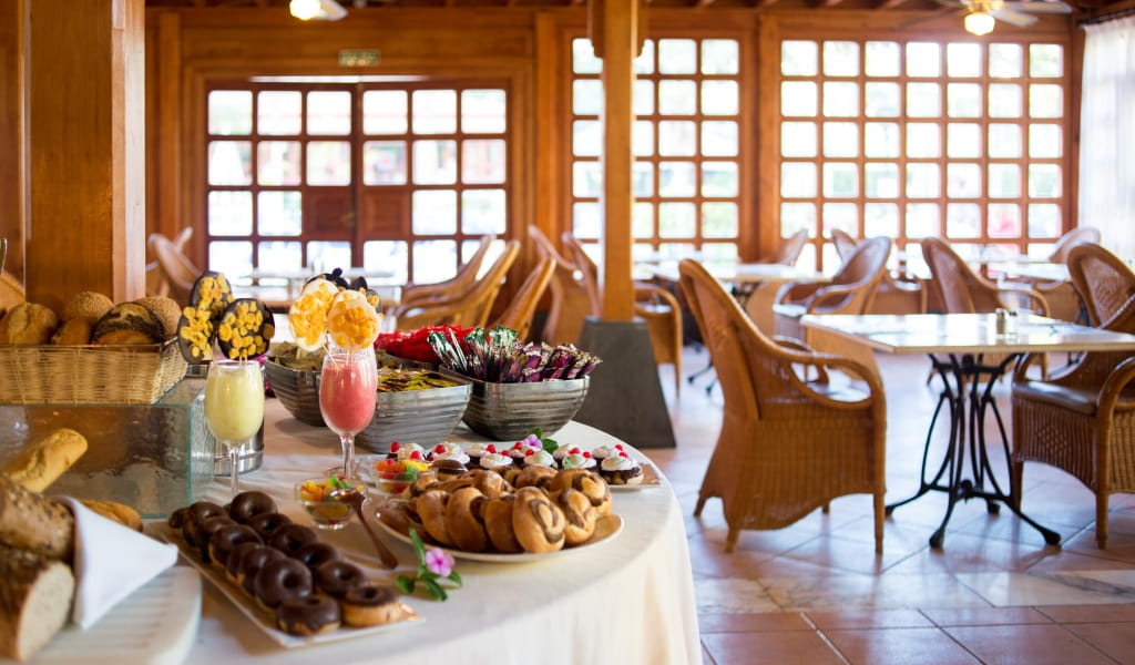 Buffet with pastries and drinks in a cozy dining room in Tenerife.