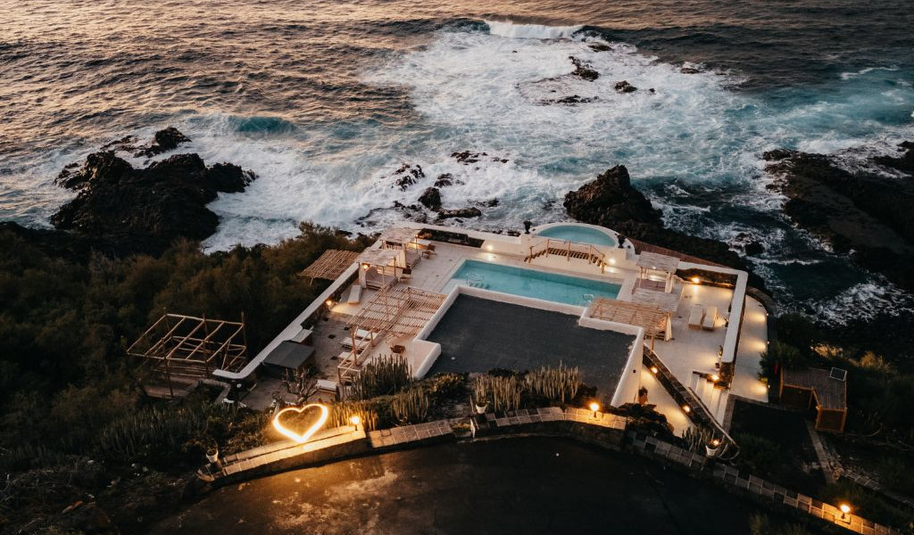 Rooftop pool overlooking ocean in Tenerife with heart-shaped decoration.