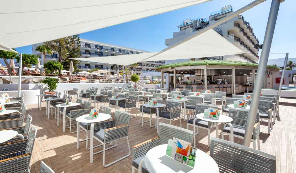Outdoor restaurant seating area with tables and chairs in Tenerife.