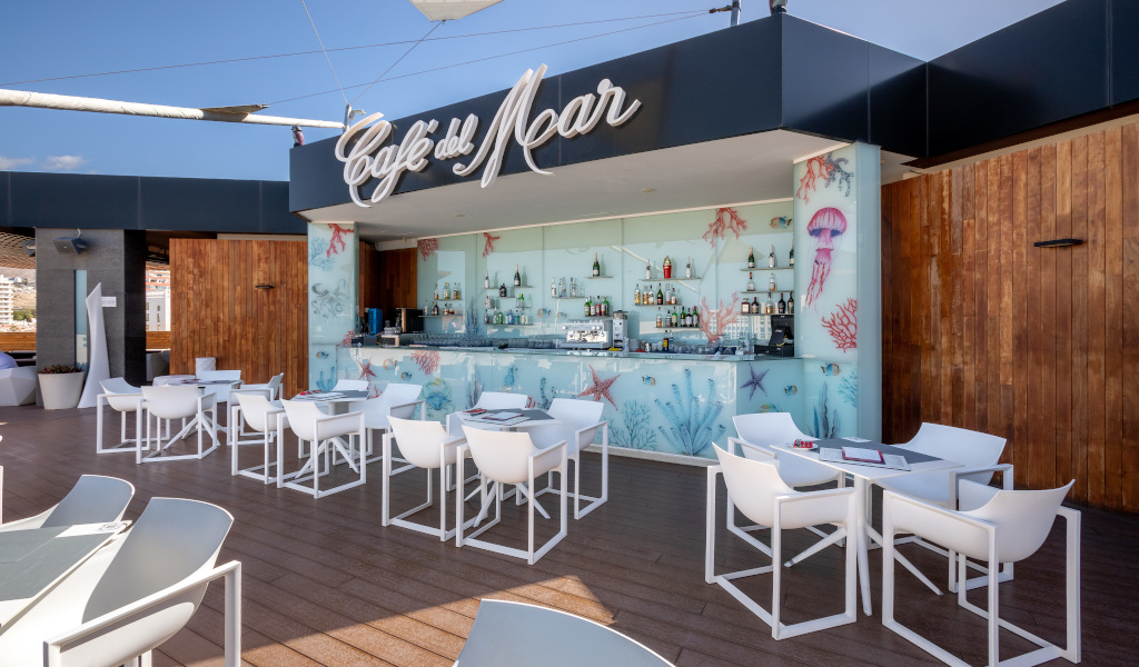 Café del Mar bar with white tables and chairs in Tenerife.