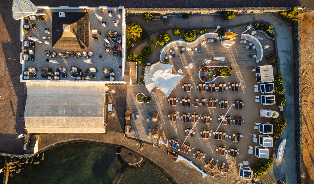 Aerial view of a beachfront restaurant and lounge chairs in Tenerife.