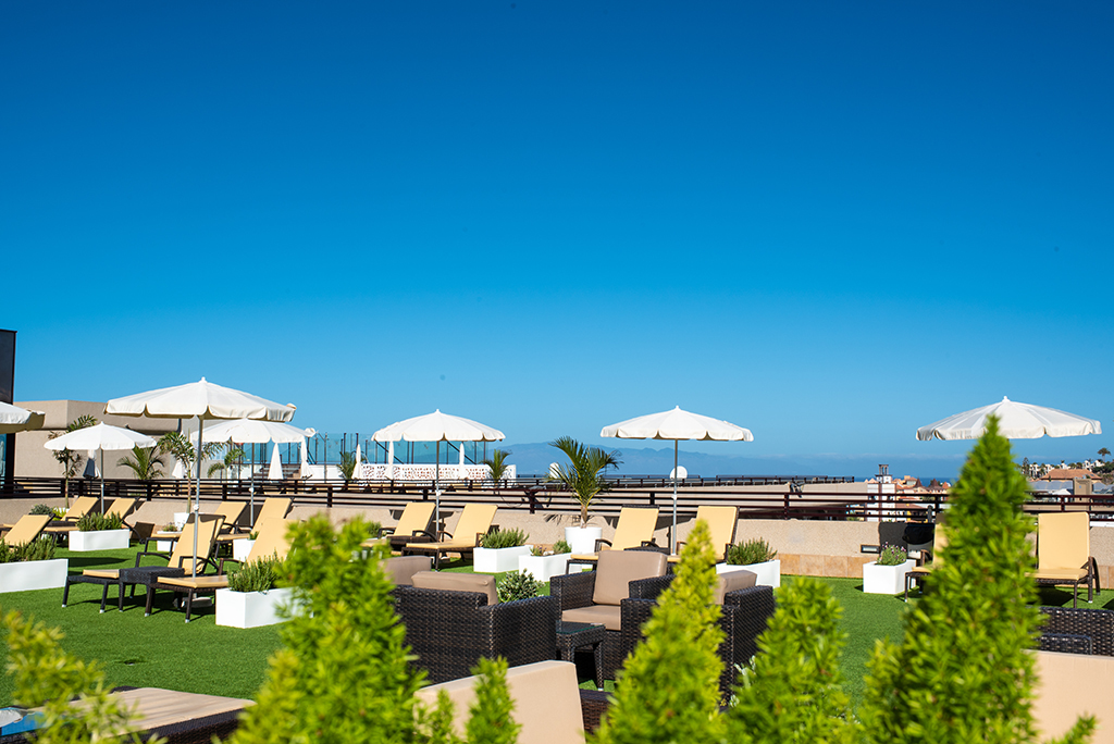 Rooftop terrace with sun loungers and umbrellas in Tenerife.
