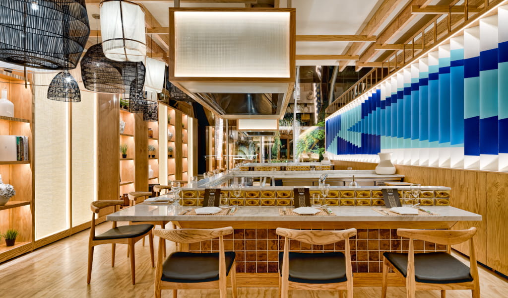 Modern restaurant interior in Tenerife with wooden decor and blue accents.