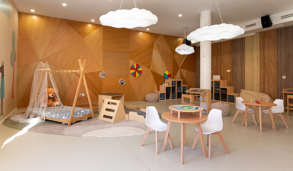 Children's playroom in Tenerife with toys, small tables, and chairs.