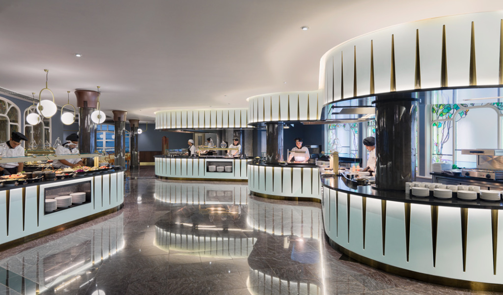Chefs preparing food at a modern buffet in Tenerife.
