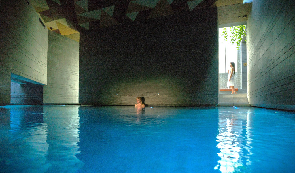 Indoor pool in a modern spa in Tenerife with a person standing by the doorway.