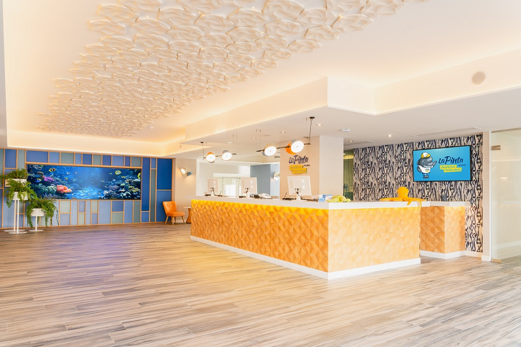 Reception area of La Pinta hotel in Tenerife with fish tank and decorative ceiling.