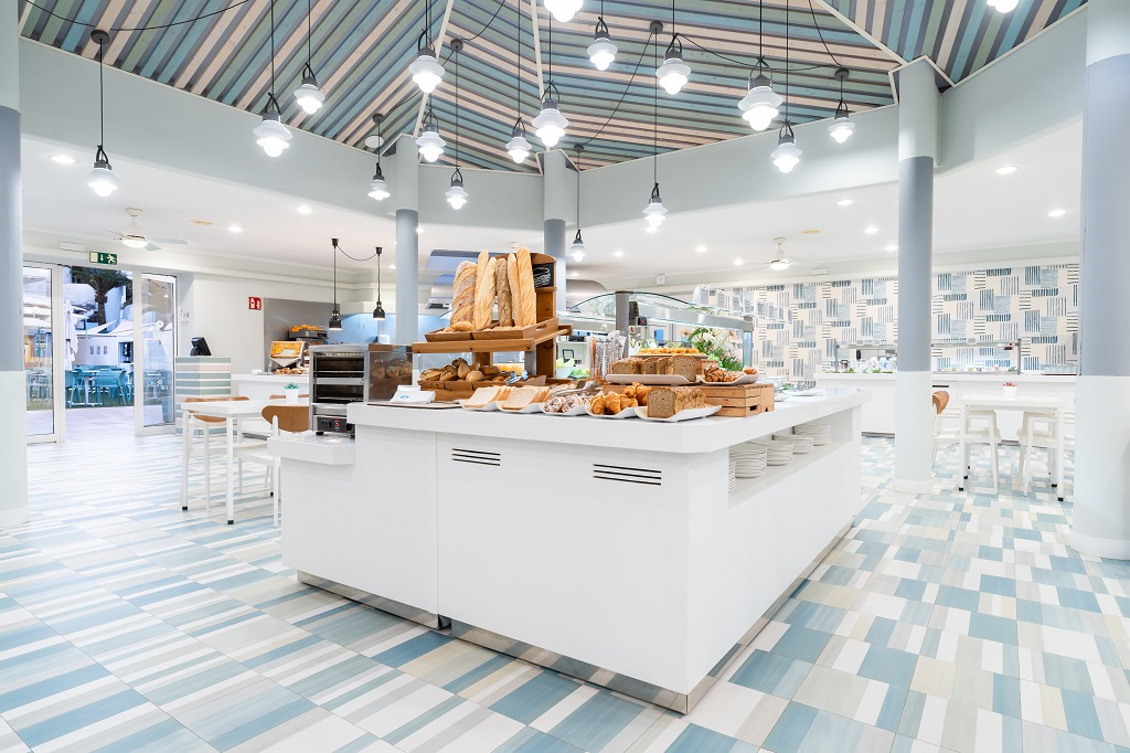 Bakery display with fresh bread and pastries inside a modern cafe in Tenerife.