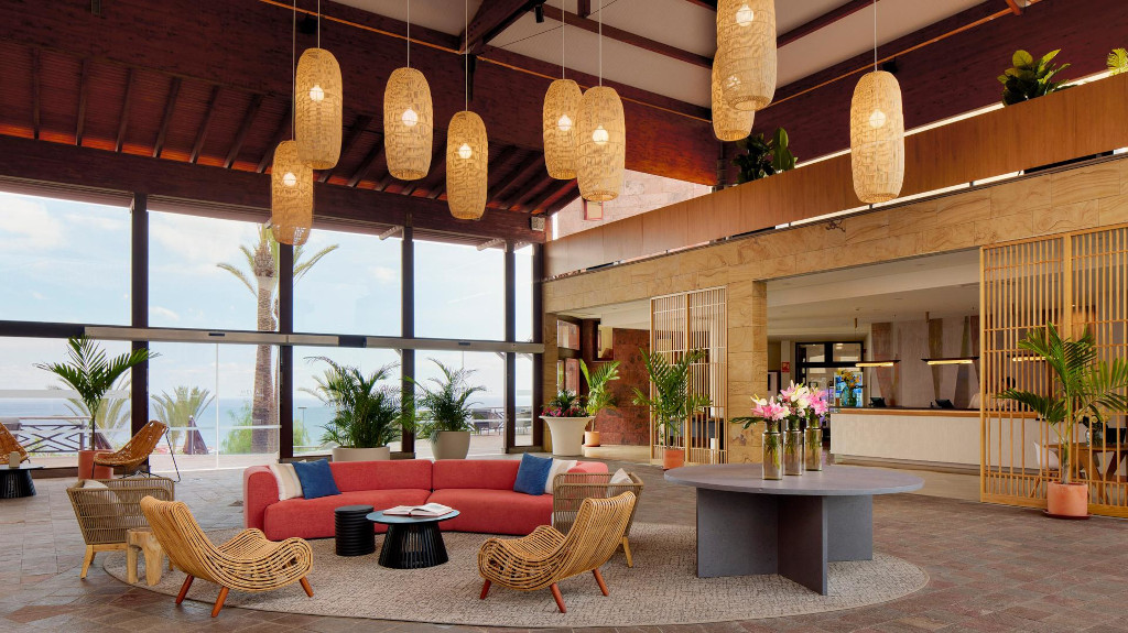 A spacious hotel lobby in Tenerife with a modern seating area and large windows.