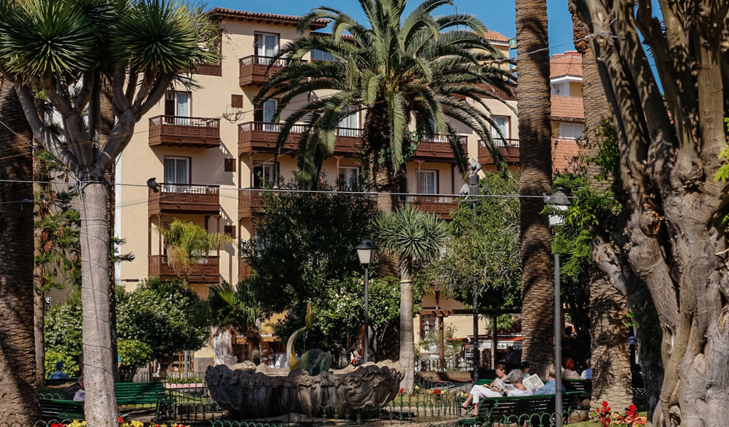 Building surrounded by palm trees in a park in Puerto de la Cruz, Tenerife.