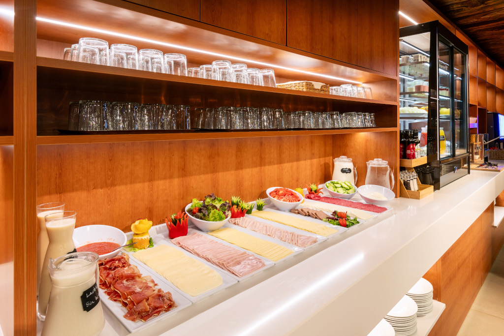 Buffet with cold meats, cheese, and vegetables in a Tenerife hotel restaurant.