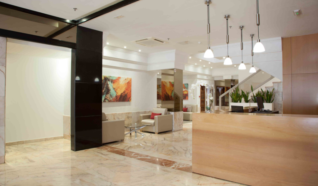 Reception area of a hotel in Tenerife with sofas and a front desk.