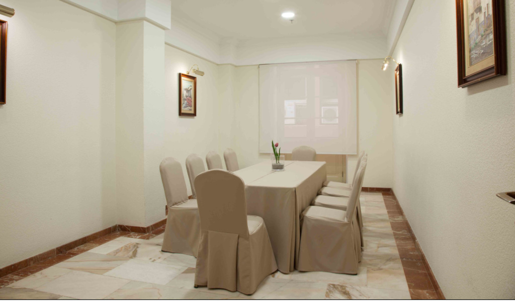 Conference room with a long table and chairs in a Tenerife hotel.